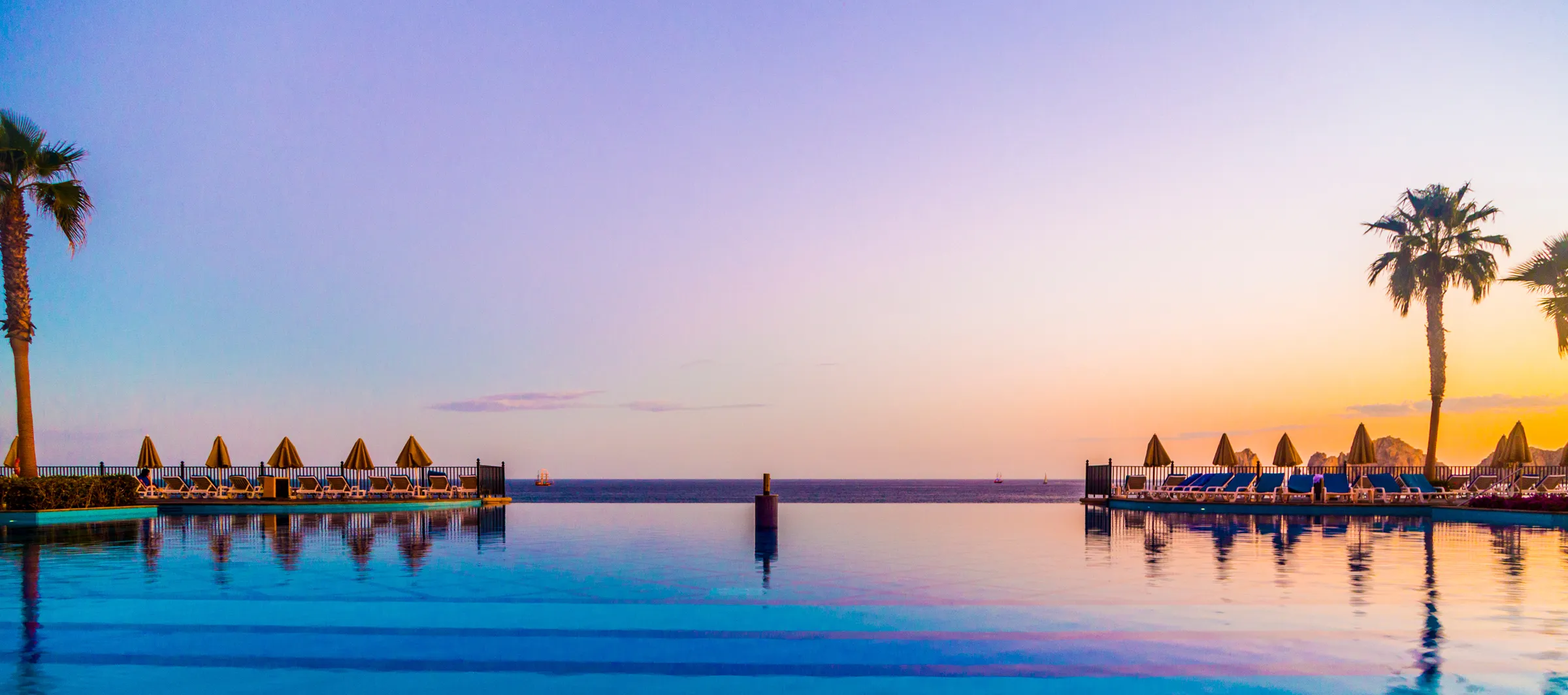 Infinity pool at a luxury beach resort in Mexico at sunset
